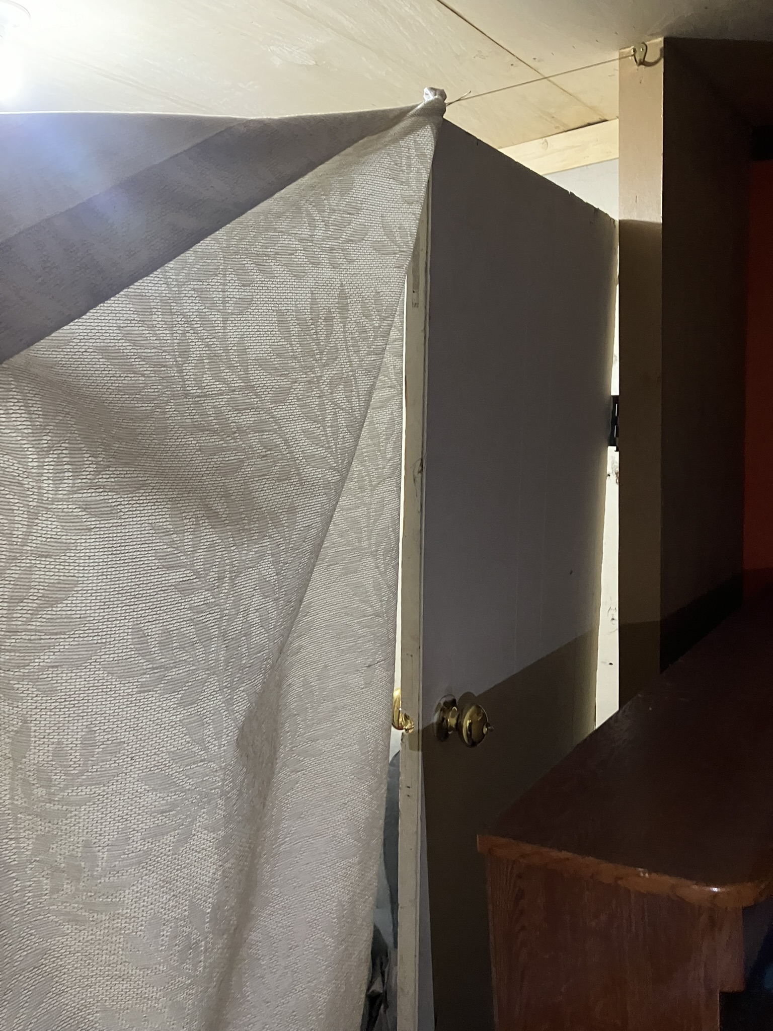 photo of a blanket used as a room divider